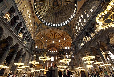 A Macedonian couple takes pictures as they visit the Byzantine monument of Hagia Sophia in Istanbul.