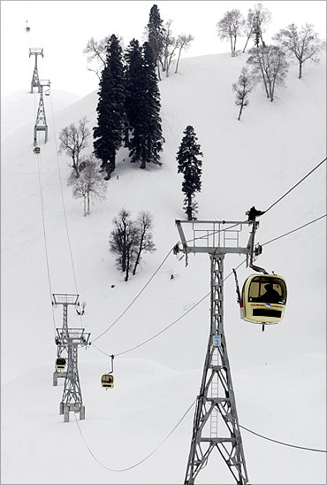 Foreign skiers travel in cable car gondolas in Gulmarg.