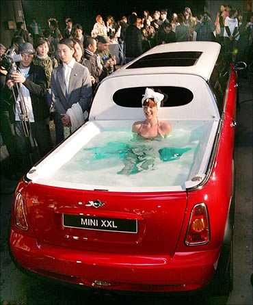 A model soaks in a jacuzzi on the rear end of a limousine named Mini XXL.