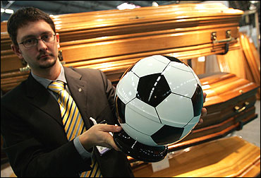 A funeral urn in the form of a soccer ball.