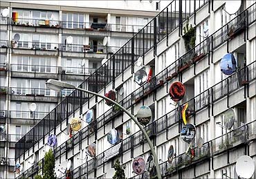 Painted satellite dishes at an apartment building.
