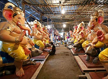 Artists put finishing touches on the idols of Ganesh.