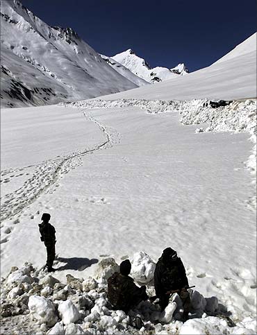 Indian army soldiers keep watch during a ceremony to open the Srinagar-Leh highway to traffic in Zojila.