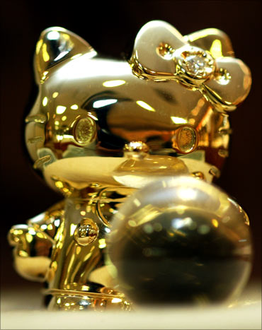 A tiny 18-karat gold Hello Kitty doll is displayed.