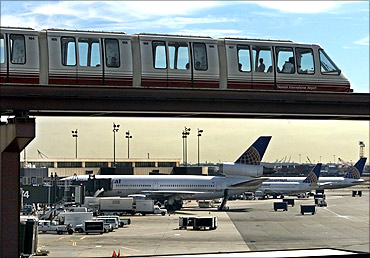 A monorail train runs past Continential Airlines jets at the Continental Airlines terminal at Newark International Airport in Newark.