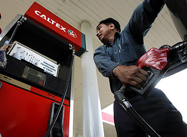A motorist fills the gas tank of his car at a petrol station in Phnom Penh.