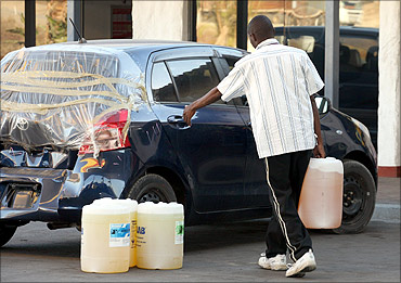 A man stocks up on fuel at a petrol station in Messina next to Beit Bridge.
