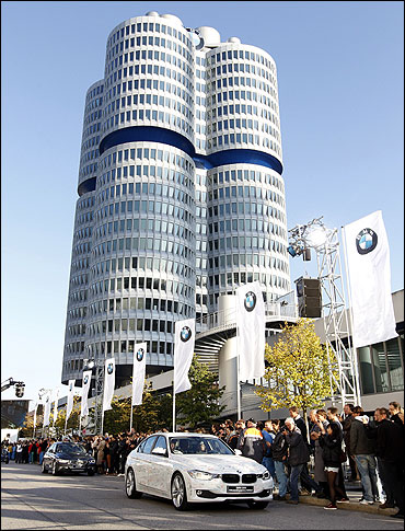 Chief Executive of German luxury carmaker BMW Norbert Reithofer sits inside the BMW 320d sedan