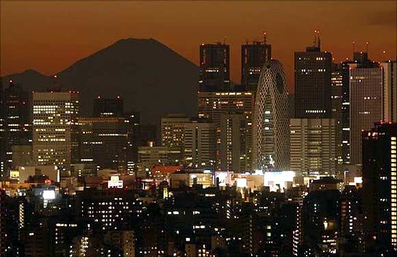 Mt. Fuji, is seen through skyscrapers in Tokyo.