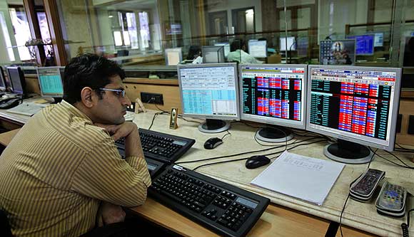 A broker monitors share prices at a brokerage firm in Mumbai.