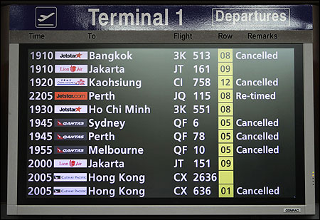 A departure board shows some of the cancelled Qantas flights at Terminal 1 in Singapore's Changi Airport.