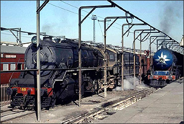Two steam engines at water refilling station at Agra station.