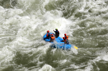 Tourists participate in white water rafting in the Chenab River in Thathri, north of Jammu.