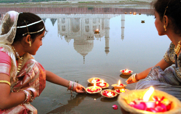 Women light 'diyas' near Taj Mahal in Agra.