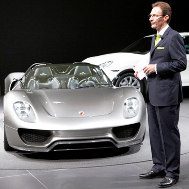 CEO Michael Macht of German car manufacturer Porsche stands beside a Porsche 918 Spyder car.