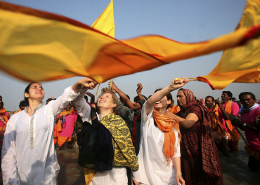 Foreign devotees chant at the confluence of Ganga and the Bay of Bengal on Sagar Island, south of Kolkata.