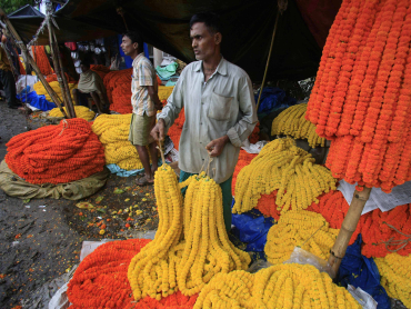 Villagers sell flower garlands at a wholesale market in Kolkata.