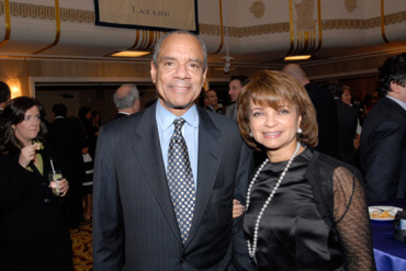 Ken Chenault, pictured here with his wife, saw a dip in compensation.