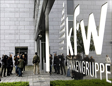 Journalists wait outside the local branch of the KfW bank in Frankfurt.