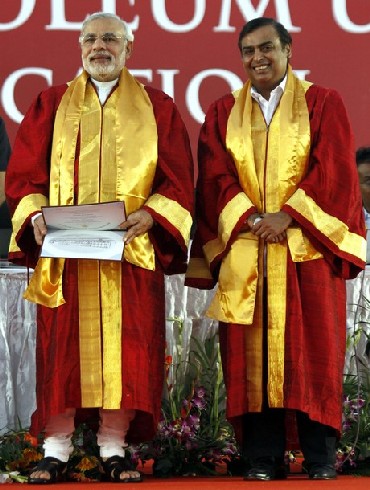 Narendra Modi (L) and Mukesh Ambani, attend a convocation ceremony at Pandit Deendayal Petroleum University in Gujarat