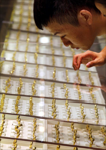 A customer at Beijing's biggest gold shop looks at gold rings on display in central Beijing.