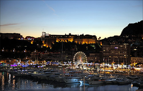 Monaco palace (top) and the port of Monaco are seen at sunset.