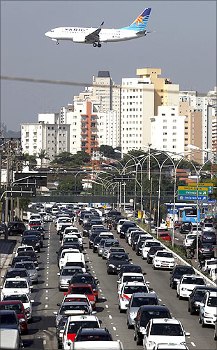 An airplane prepares to land over a jammed highway during a normal weekday at Congonhas Airport, one of Sao Paulo's two busy airports.