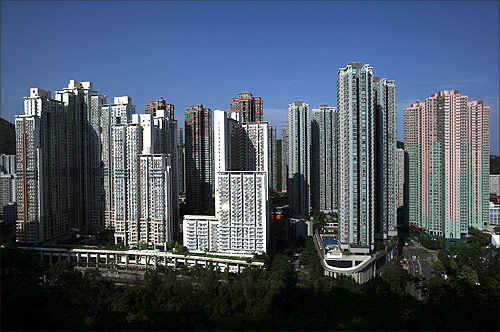 Sunlight is reflected on a window as private and public residential buildings are seen in Po Lam, a satellite town in Hong Kong.