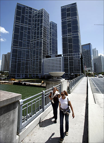 People walk past the Icon Brickell condo, billionaire Jorge Perez's latest project, in downtown Miami, Florida.