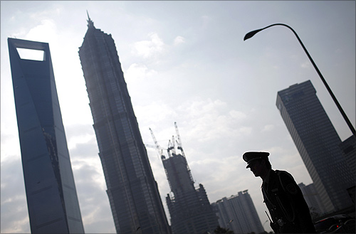A security guard stands in the financial district of Pudong in Shanghai.