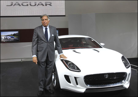 Ratan Tata poses with Jaguar's newly launched C-X16 car during India's Auto Expo, in New Delhi on January 5, 2012.