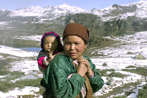 A Monpa tribal woman carries her child near the border with China in Sella, located at a height of 13,000ft in Arunachal Pradesh.