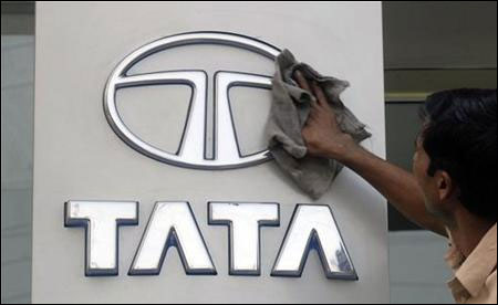 A worker cleans a Tata Motors logo outside its showroom in Hyderabad.