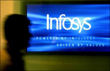 A man walks past a billboard of Infosys Technologies's office in Bangalore.
