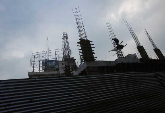 A labourer works at an under-construction shopping mall in Patna.