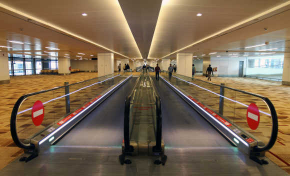 Passengers walk inside the T3 terminal of Indira Gandhi International Airport in New Delhi.