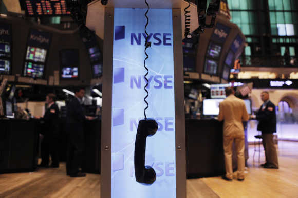 A phone hangs above the floor of the New York Stock Exchange shortly after the opening of the market.