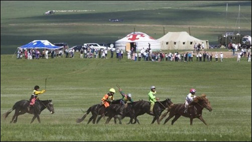 hildren ride horses during a horse racing competition at the annual Naadam Festival in Ulan Bator.