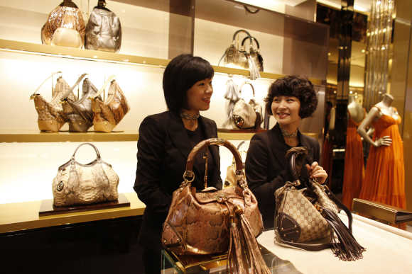Staff members of the Gucci flagship store in Shanghai chat.