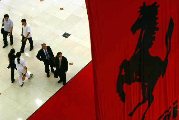 Visitors pass under a huge Ferrari banner at an upscale shopping mall in Shanghai.