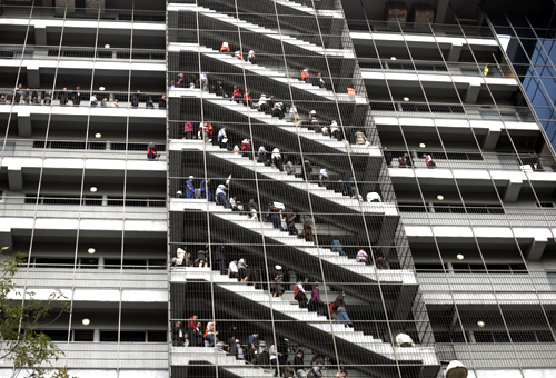 People stand at the emergency stairs in an office building during an earthquake drill in Mexico City.