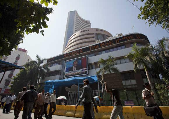 People walk outside the Bombay Stock Exchange building.