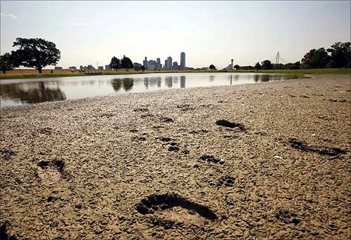 Footprints mark the bank of a partially dried-up pond near downtown Dallas, Texas.