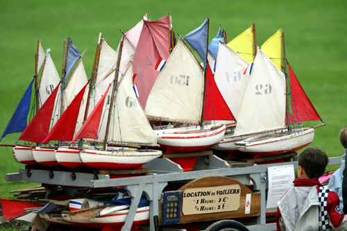 A boy looks at model boats for hire at the pond of Jardin du Luxembourg in Paris.