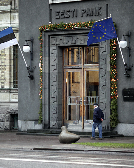 A man walks past Estonia's central bank building in Tallinn.