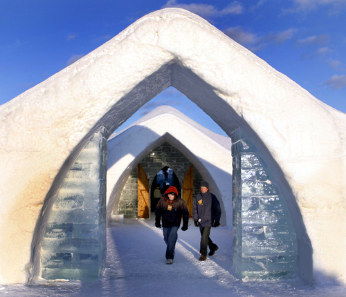 Visitors walk out of Ice Hotel in Sainte-Catherine-de-la-Jacques-Cartier, Quebec.