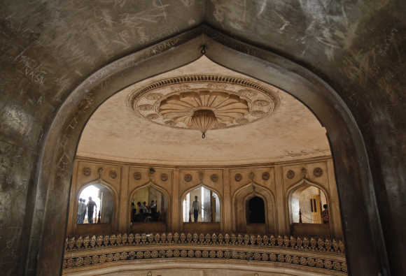 Tourists are pictured through an archway inside the Charminar in Hyderabad.