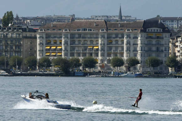 A wakeboarder performs on Lake Leman on a hot autumn day in Geneva.