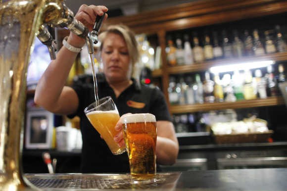 Barmaid pours a glass of beer in Sydney.