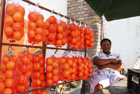 A fruit seller sits near Gaborone, Botswana.